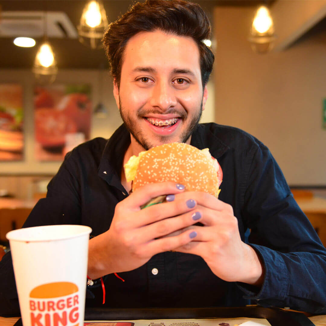 Young man enjoying a Burger King hamburger